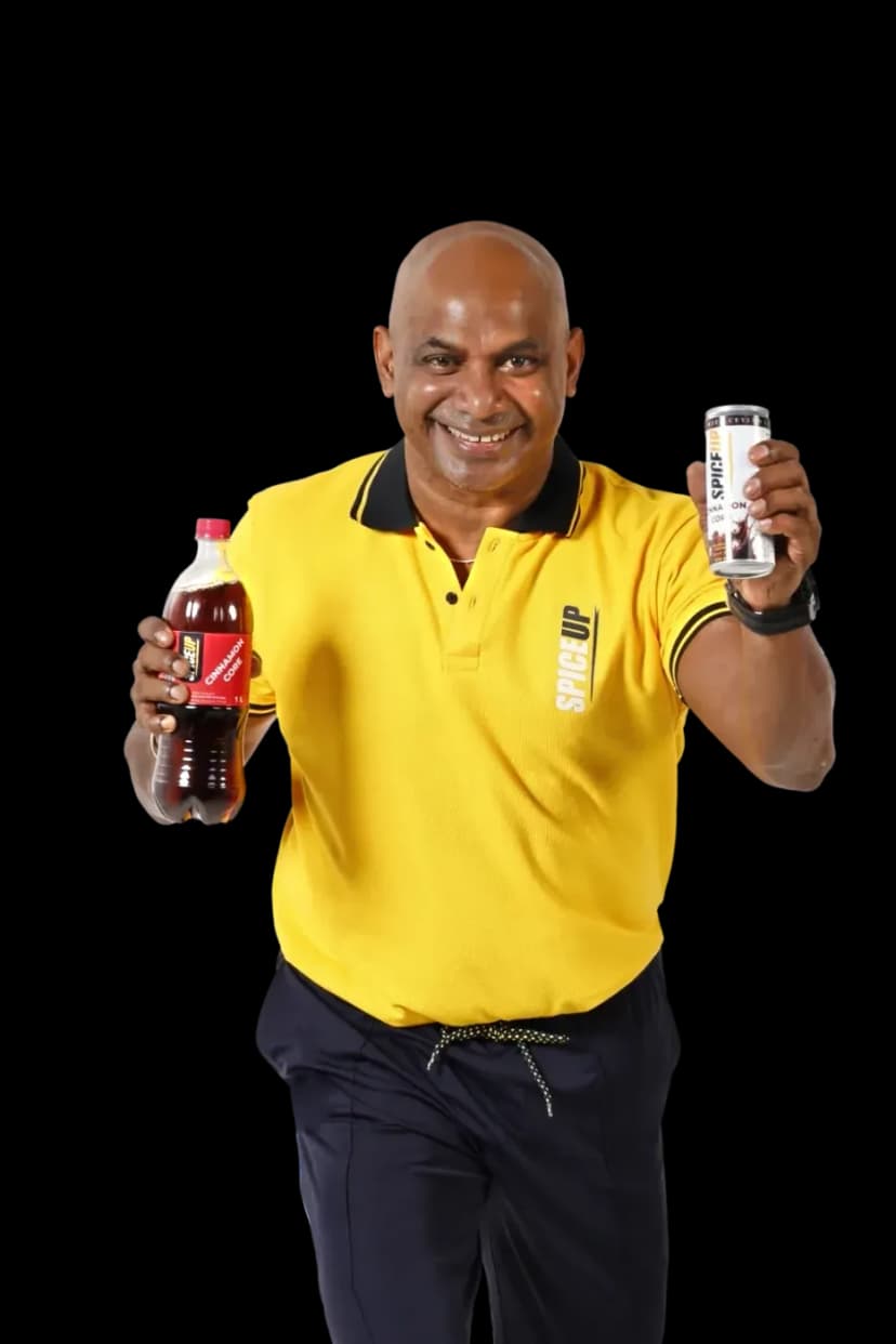 Brand ambassador raising a SPICEUP can and a Cinnamon Core PET bottle